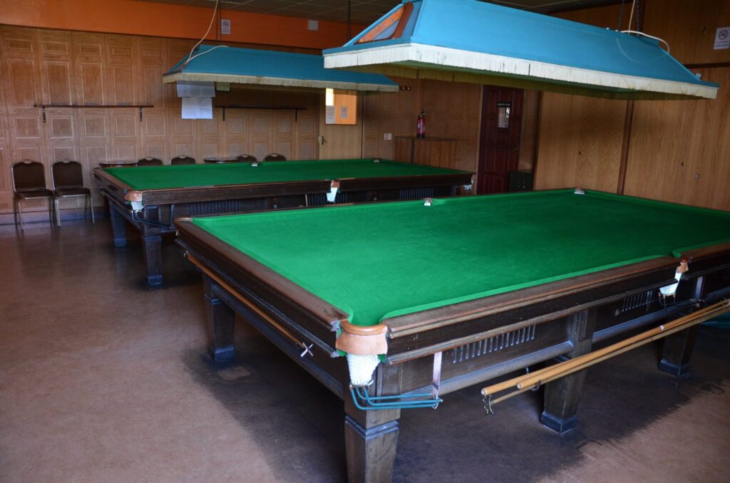 Snooker tables at Leigh Park Social Club, highlighting activities such as live sports, snooker, pool, darts, and more.