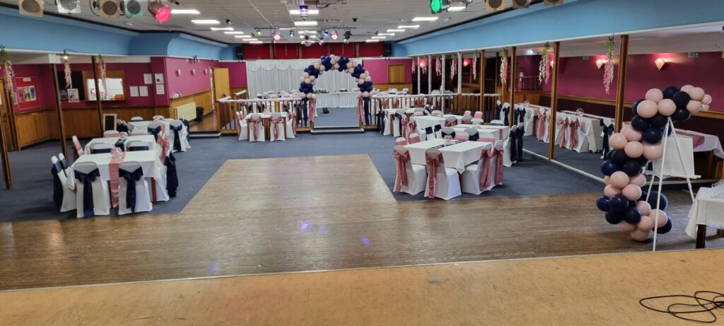 Spacious main room at Leigh Park Social Club set up for a party with elegant decorations, round tables, and a dance floor, perfect for weddings, receptions, and events.