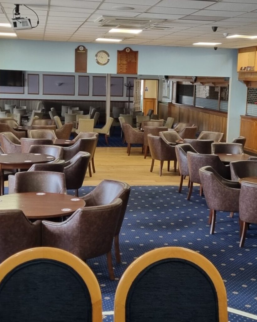 General room at Leigh Park Social Club featuring a fully stocked Greene King bar, perfect for casual gatherings and social events