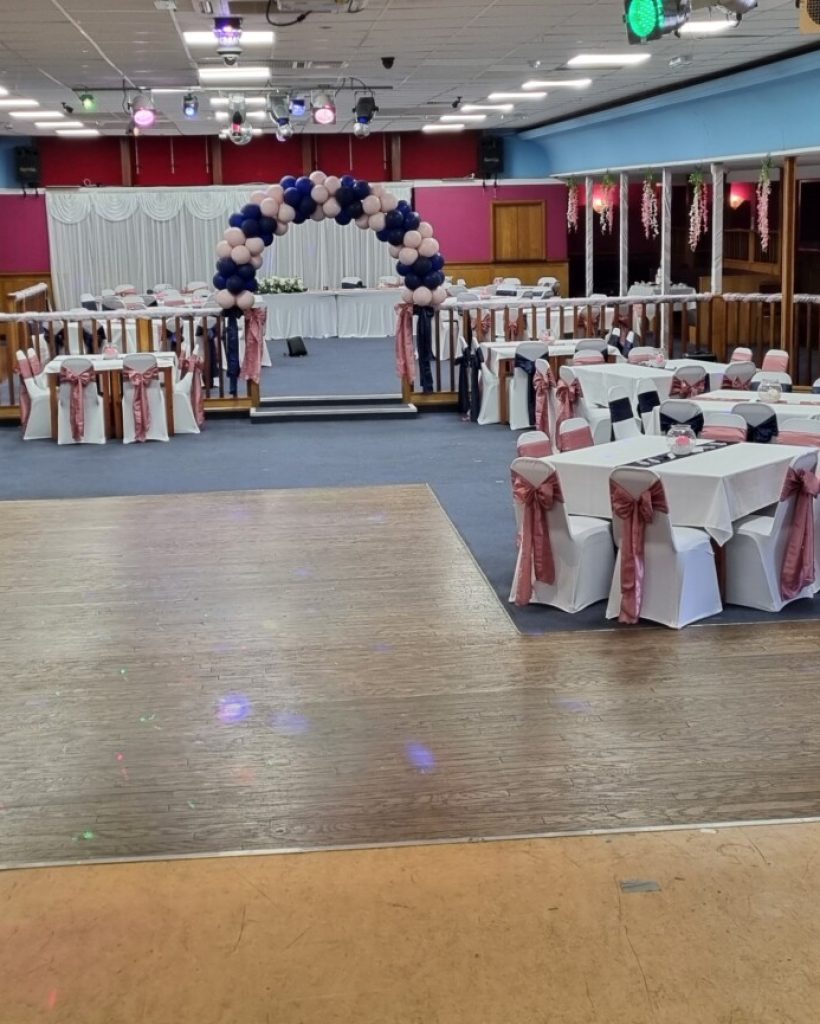 Spacious main room at Leigh Park Social Club set up for a party with elegant decorations, round tables, and a dance floor, perfect for weddings, receptions, and events.